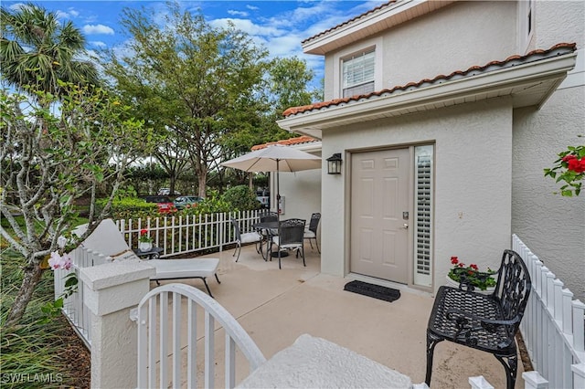 view of patio with fence and outdoor dining area