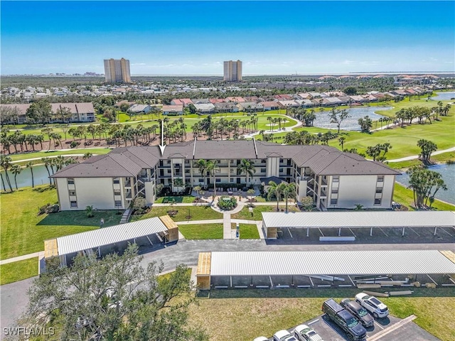 bird's eye view with view of golf course, a water view, and a residential view