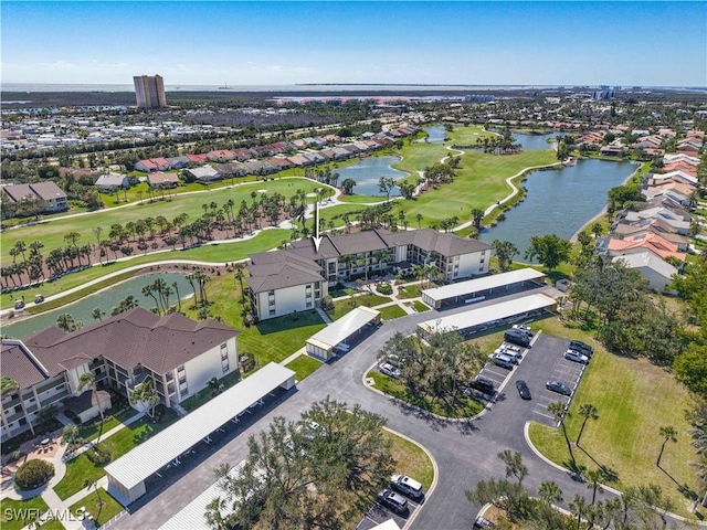 birds eye view of property featuring a water view, view of golf course, and a residential view