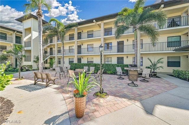 view of property's community with a patio area