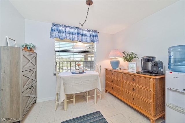 dining space with light tile patterned floors and baseboards