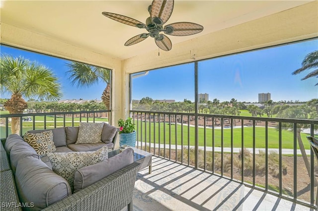 sunroom / solarium featuring a ceiling fan