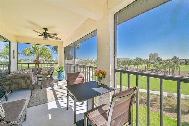 sunroom / solarium featuring ceiling fan