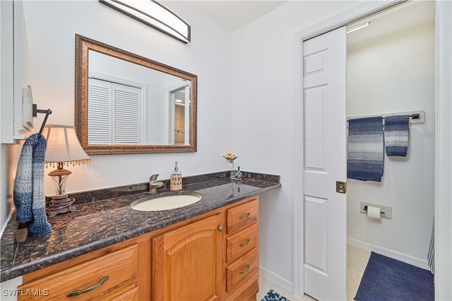 bathroom featuring tile patterned floors, vanity, and baseboards