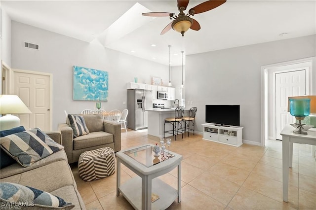 living room featuring light tile patterned floors, ceiling fan, recessed lighting, visible vents, and baseboards