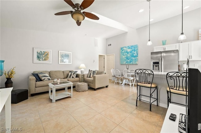 living room with ceiling fan, high vaulted ceiling, light tile patterned flooring, and visible vents