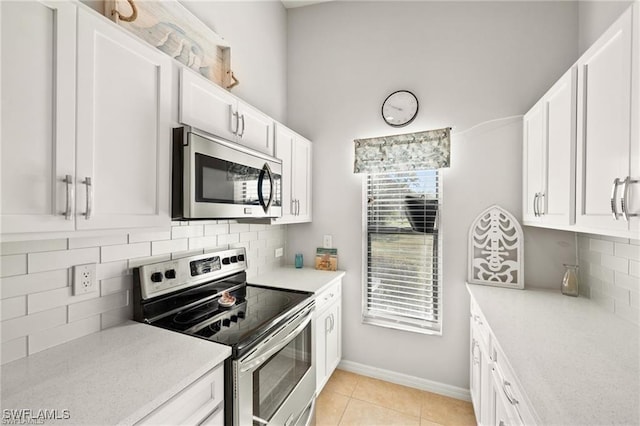 kitchen featuring appliances with stainless steel finishes, light countertops, and light tile patterned flooring