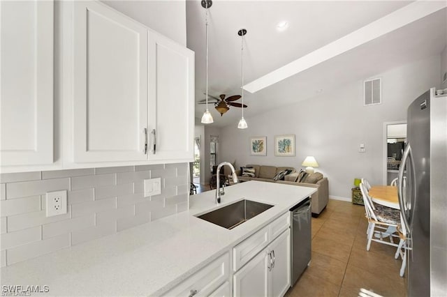 kitchen featuring light tile patterned floors, visible vents, appliances with stainless steel finishes, open floor plan, and a sink