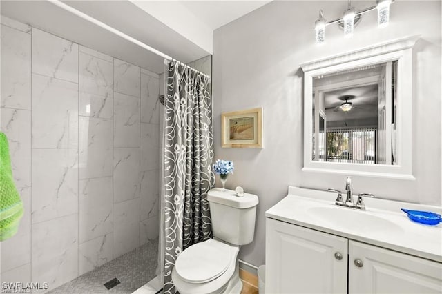 bathroom with toilet, a tile shower, and vanity