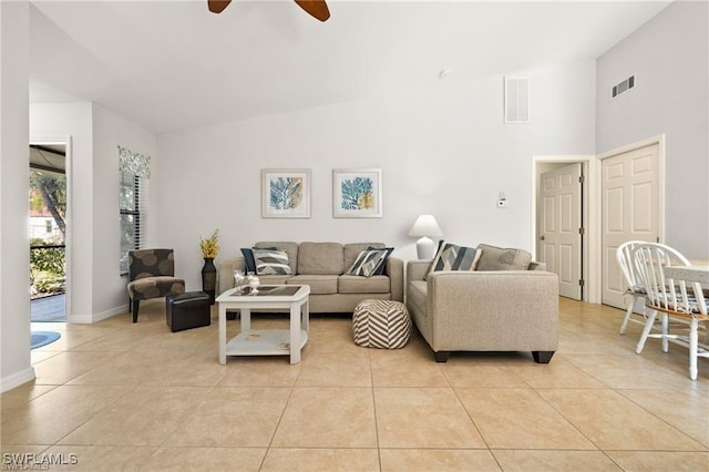 living area featuring baseboards, light tile patterned flooring, visible vents, and a ceiling fan