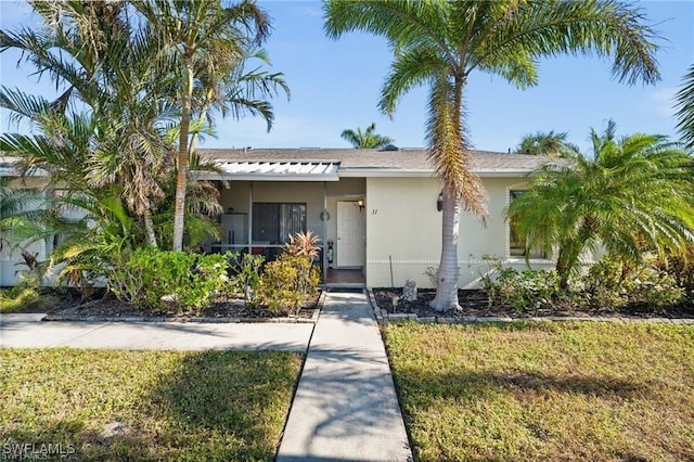 view of front of property featuring a front yard and stucco siding