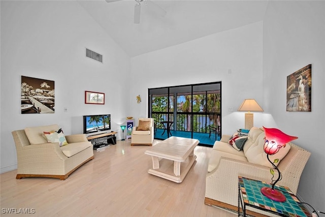 living room with high vaulted ceiling, wood finished floors, visible vents, and a ceiling fan