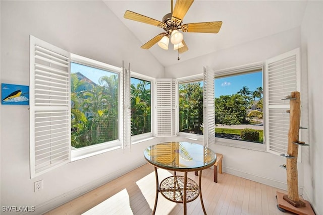 sunroom featuring lofted ceiling and ceiling fan