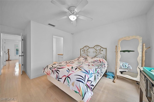 bedroom featuring light wood finished floors, baseboards, visible vents, and a ceiling fan