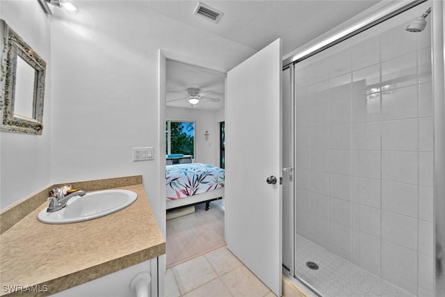 ensuite bathroom featuring visible vents, ensuite bathroom, ceiling fan, a shower stall, and vanity