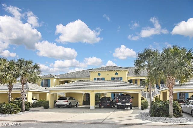 view of building exterior with driveway and an attached garage