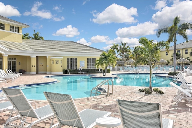 pool with fence and a patio