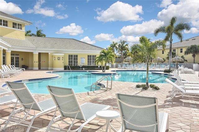 community pool featuring a patio and fence