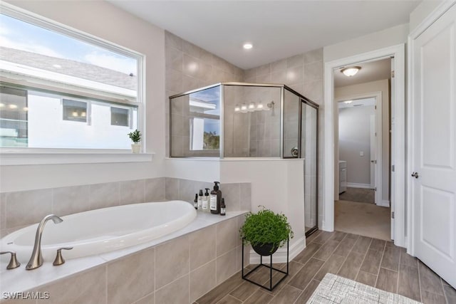 bathroom featuring a stall shower, recessed lighting, a garden tub, and wood finish floors