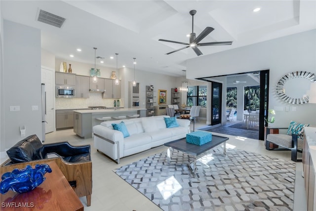 living room with coffered ceiling, recessed lighting, visible vents, and a ceiling fan