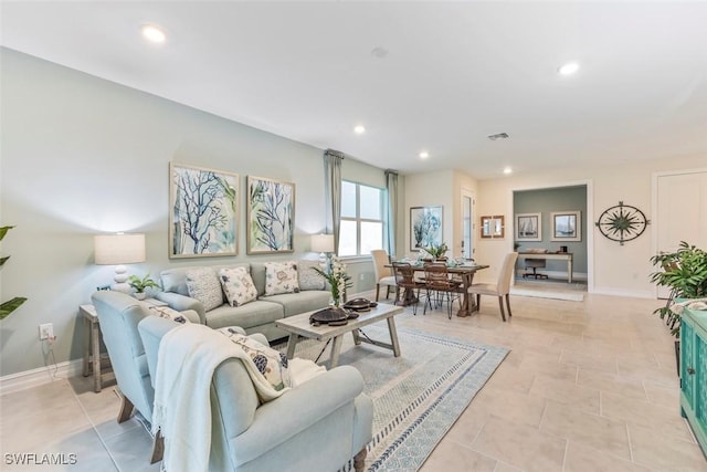 living area with baseboards, light tile patterned flooring, visible vents, and recessed lighting