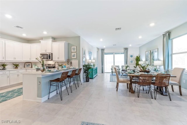 dining space with recessed lighting, visible vents, and plenty of natural light