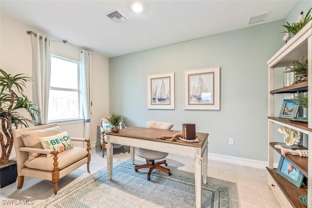 office featuring light tile patterned flooring, visible vents, and baseboards