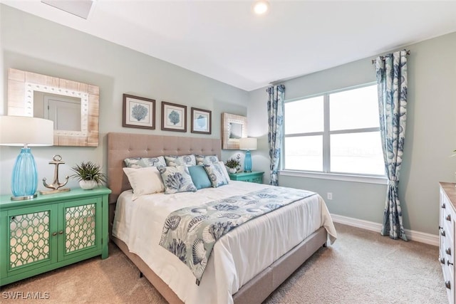 bedroom with light carpet and baseboards