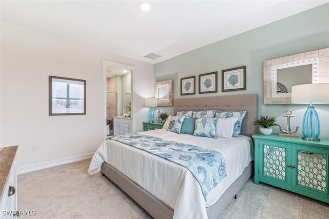 bedroom with carpet floors, baseboards, visible vents, and connected bathroom