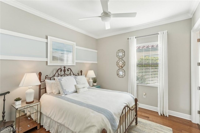 bedroom featuring ceiling fan, baseboards, wood finished floors, and ornamental molding