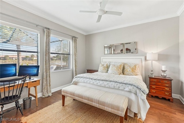 bedroom featuring ceiling fan, crown molding, baseboards, and wood finished floors