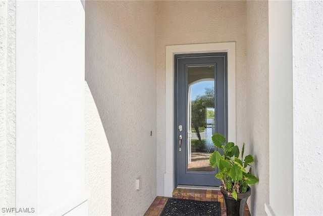 entrance to property with stucco siding