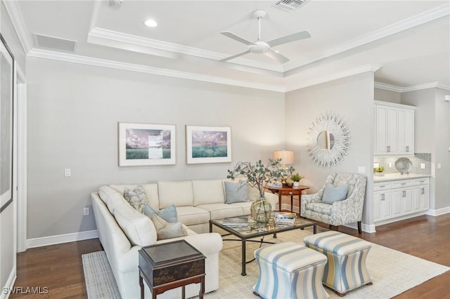 living room featuring visible vents, a raised ceiling, and dark wood-type flooring