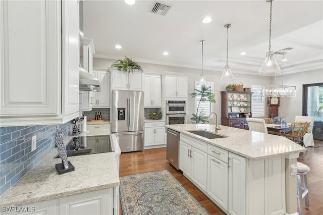 kitchen with appliances with stainless steel finishes, white cabinets, and a sink