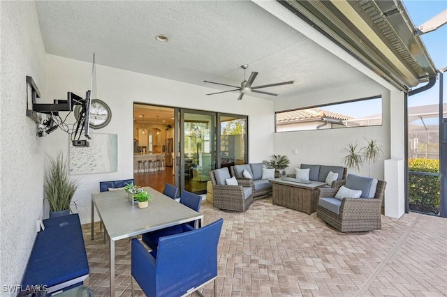 view of patio / terrace with outdoor dining area, outdoor lounge area, a lanai, and a ceiling fan