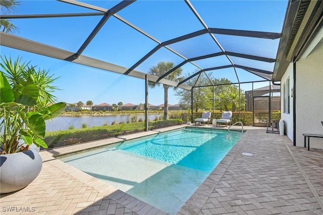 outdoor pool featuring a lanai, a water view, and a patio