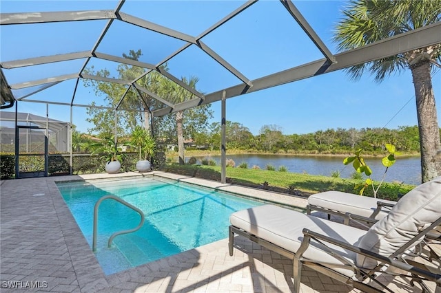 outdoor pool with a lanai, a water view, and a patio