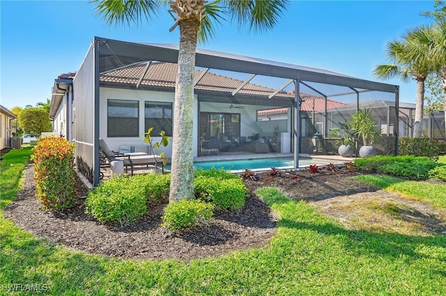 rear view of property with glass enclosure, a patio area, and an outdoor pool