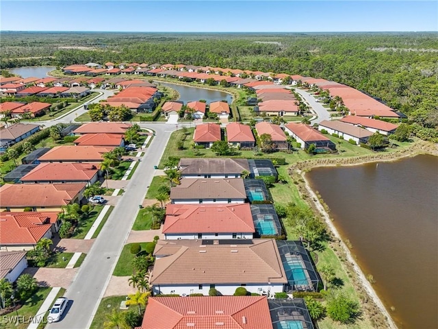 birds eye view of property featuring a residential view and a water view