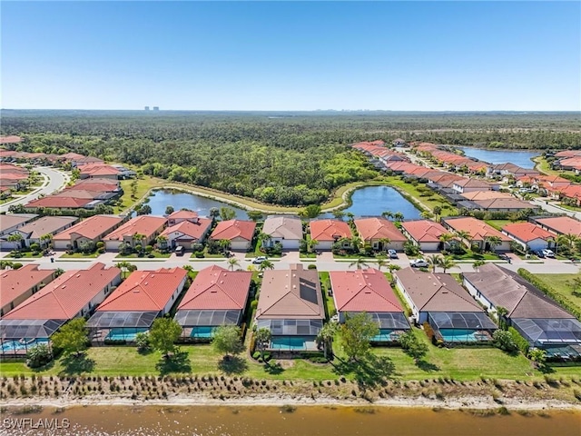 drone / aerial view featuring a water view and a residential view