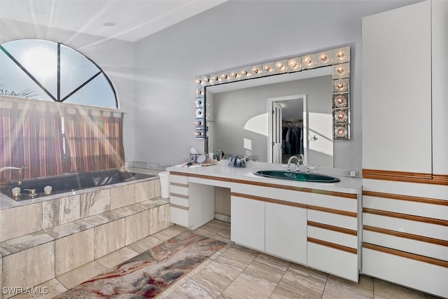 bathroom with a bath and vanity
