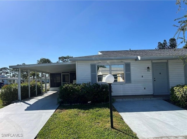 view of front facade with a carport and driveway