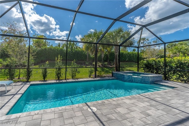 view of swimming pool featuring a pool with connected hot tub, a lanai, and a patio