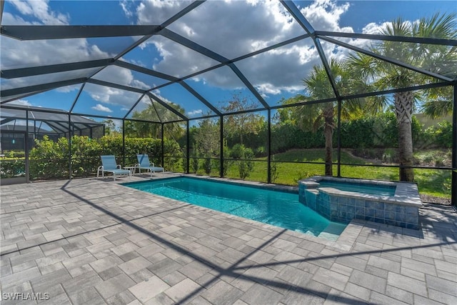 view of pool featuring a pool with connected hot tub, glass enclosure, and a patio