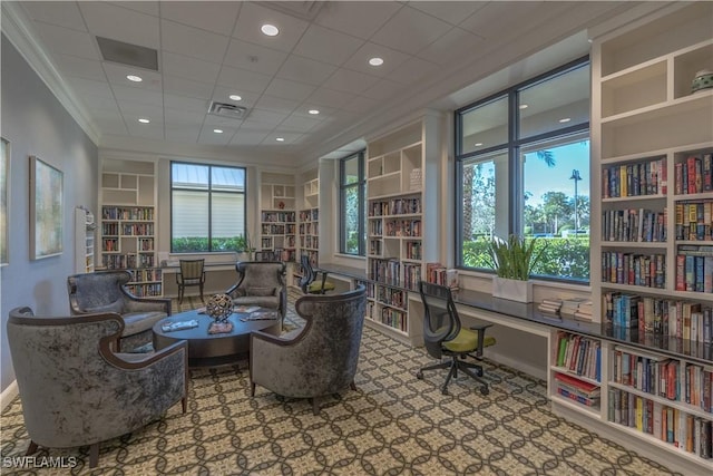 living area with recessed lighting, bookshelves, visible vents, ornamental molding, and carpet flooring