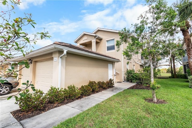 view of home's exterior with a garage, a yard, and stucco siding