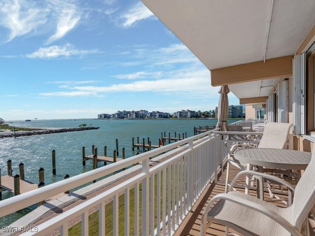 balcony with a dock and a water view