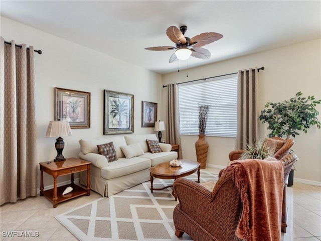 living room featuring ceiling fan, light tile patterned flooring, and baseboards