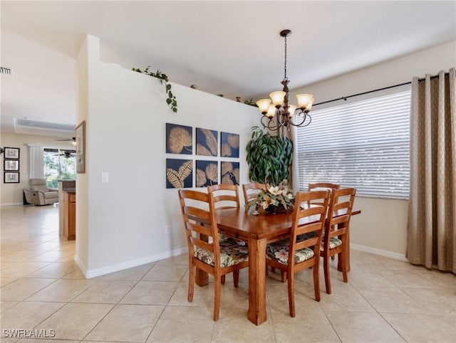 dining area featuring light tile patterned flooring, visible vents, and an inviting chandelier