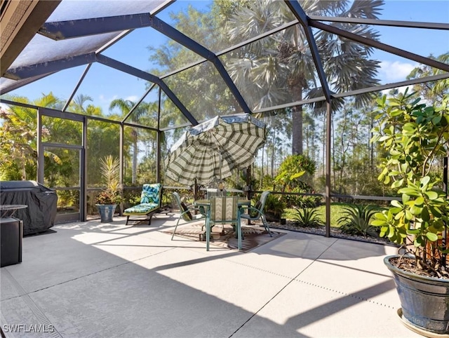 view of patio / terrace featuring outdoor dining area, a grill, and a lanai